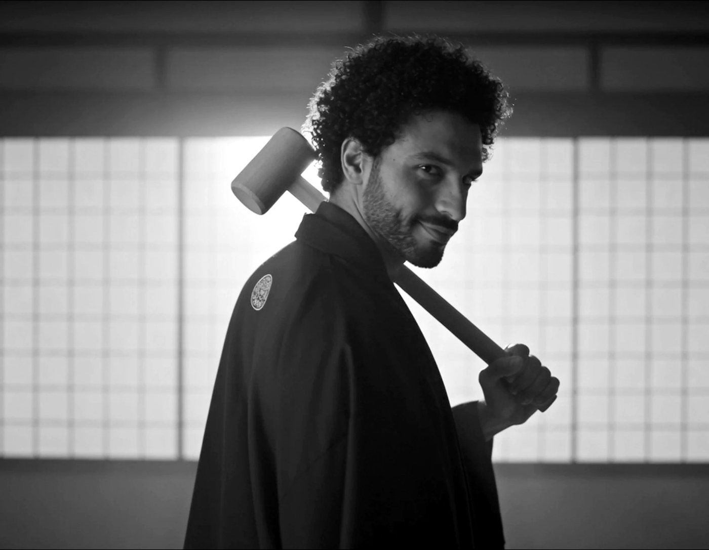 Samurai holding a wooden mallet over his shoulder